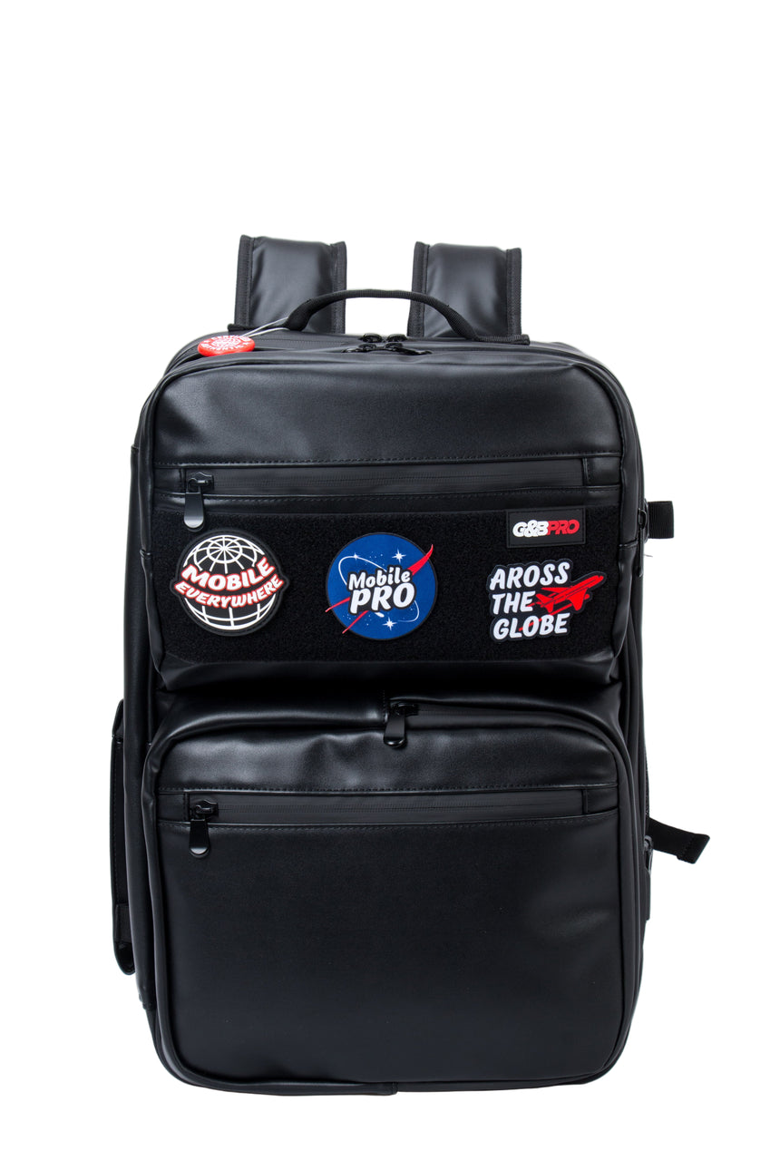 Black backpack with various patches on a white background