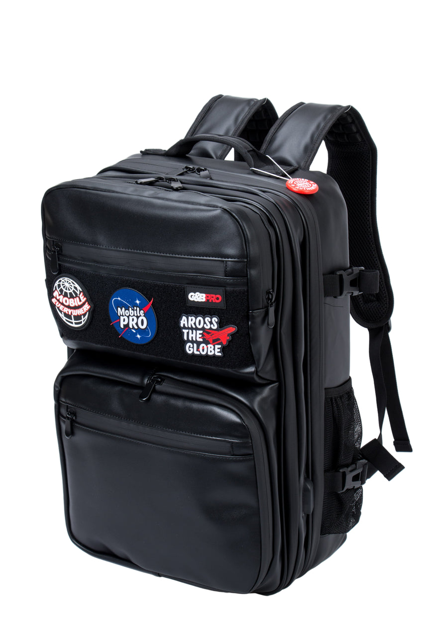 Black backpack with various patches on a white background