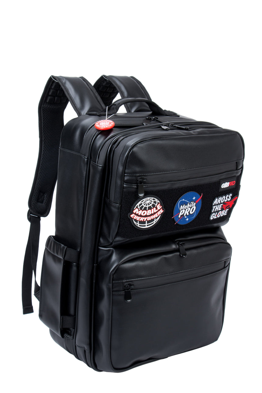 Black backpack with multiple patches on a white background