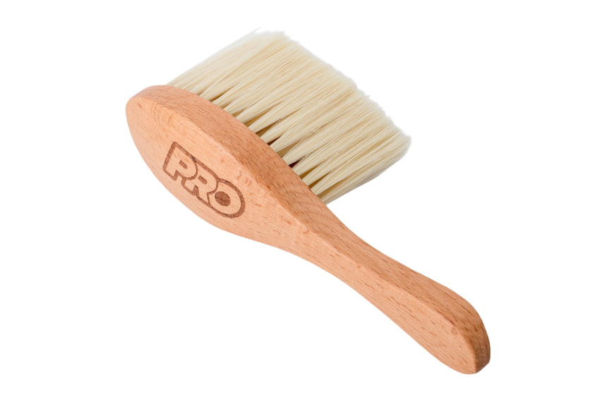 Hairbrush with wooden handle and natural bristles on a white background