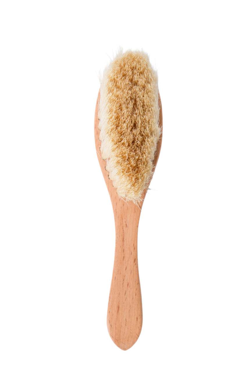 Wooden brush with bristles on a white background