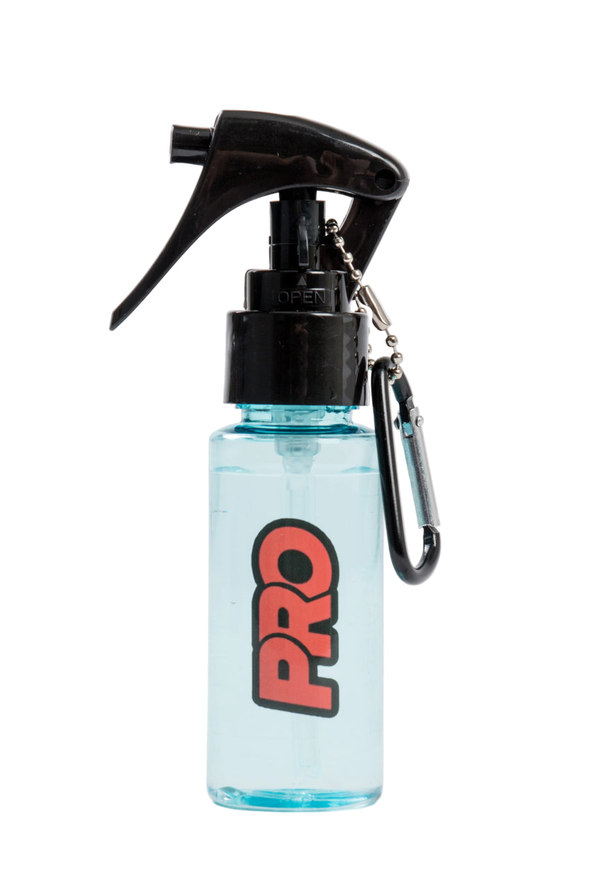 Small spray bottle with black nozzle and 'PRO' logo on a light gray background