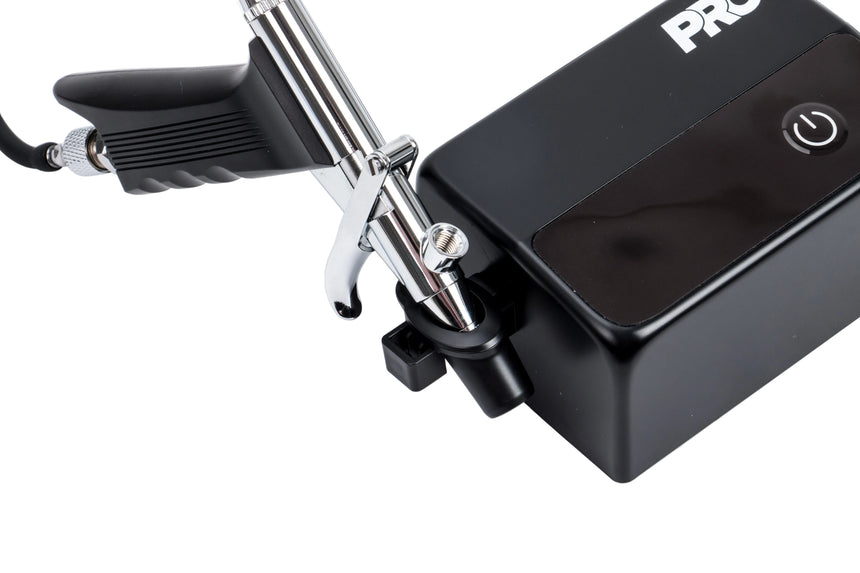Black airbrush gun with a visible brand logo on a white background