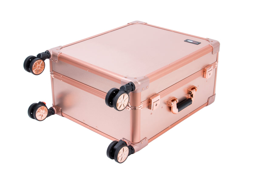 Rose gold suitcase with black wheels on a white background
