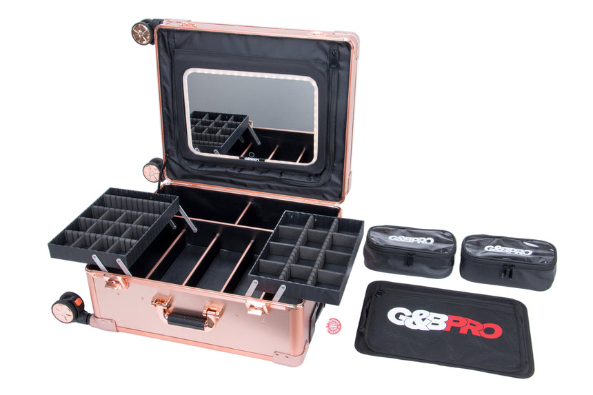 Rose gold makeup case with compartments and a mirror, accompanied by black trays and a G&G Pro mat on a white background.