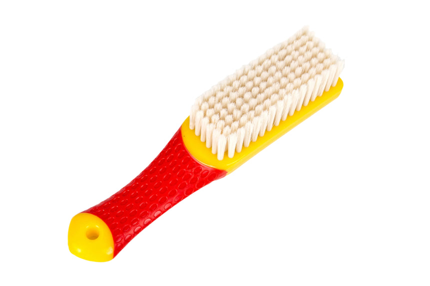 Red and yellow brush with a white bristle head on a white background