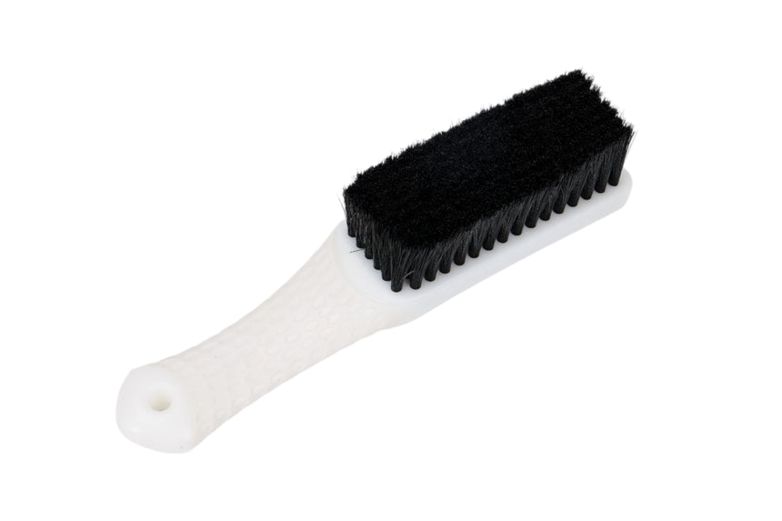White brush with black bristles on a white background