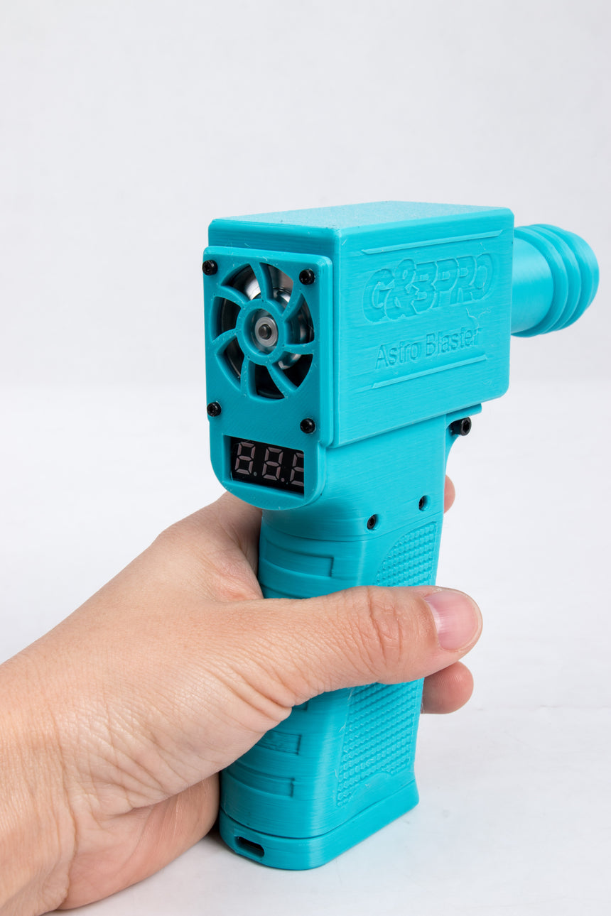 Turquoise thermal imaging gun held by a hand on a white background