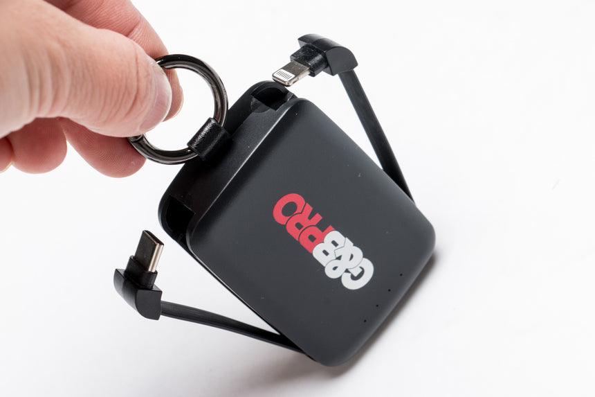 Black portable charger with 'Cuddeback' branding on a white background