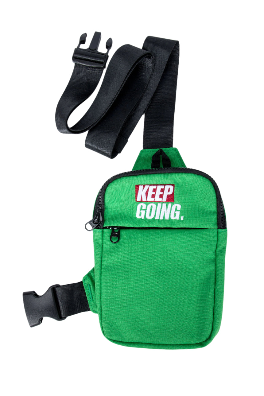 Green shoulder bag with 'KEEP GOING.' text on a white background