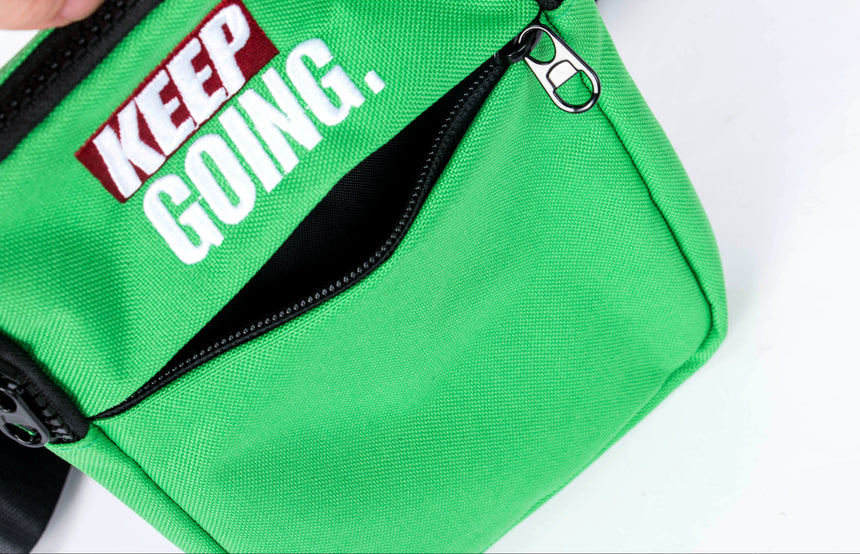 Green bag with 'KEEP GOING.' text on a white background