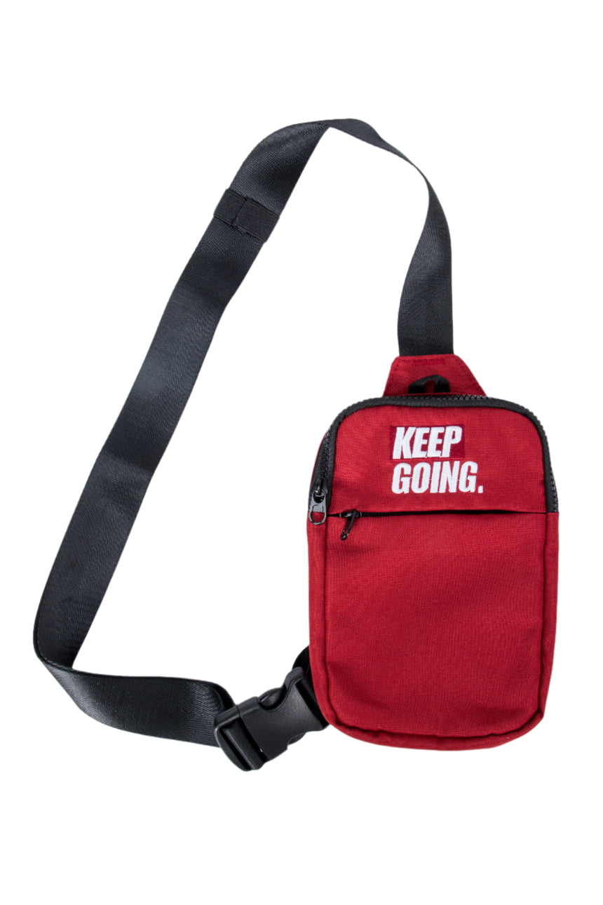 Red sling bag with 'KEEP GOING.' text on a white background