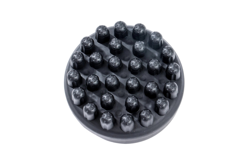 Black rubber brush with raised cylindrical bristles on a white background