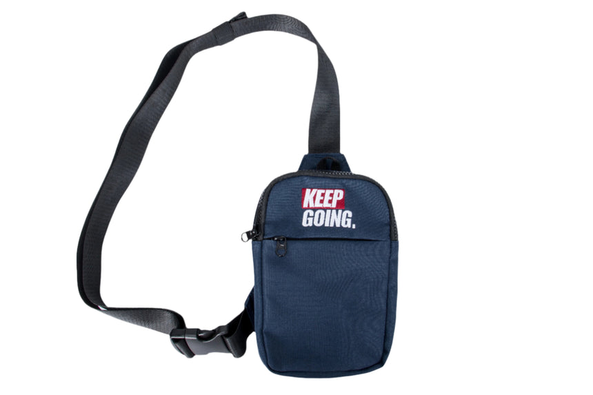 Navy blue crossbody bag with 'KEEP GOING' text on a white background