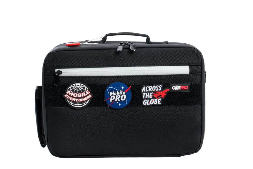 Black bag with various patches on a white background