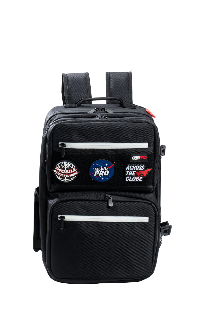 Black backpack with various patches on a white background