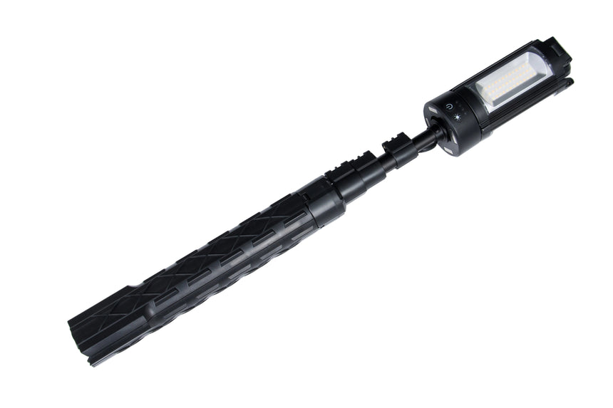 Black flashlight with attached lamp on a white background