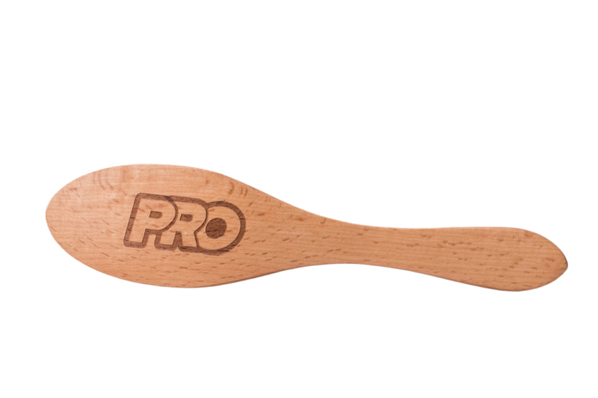 Wooden hairbrush with 'PRO' branding on a light gray background