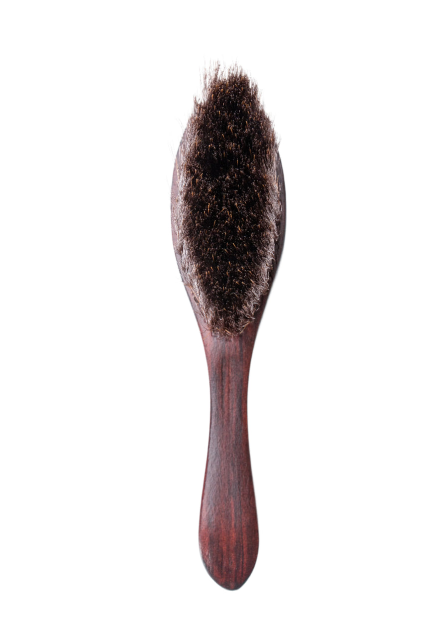 Wooden hairbrush with bristles on a white background