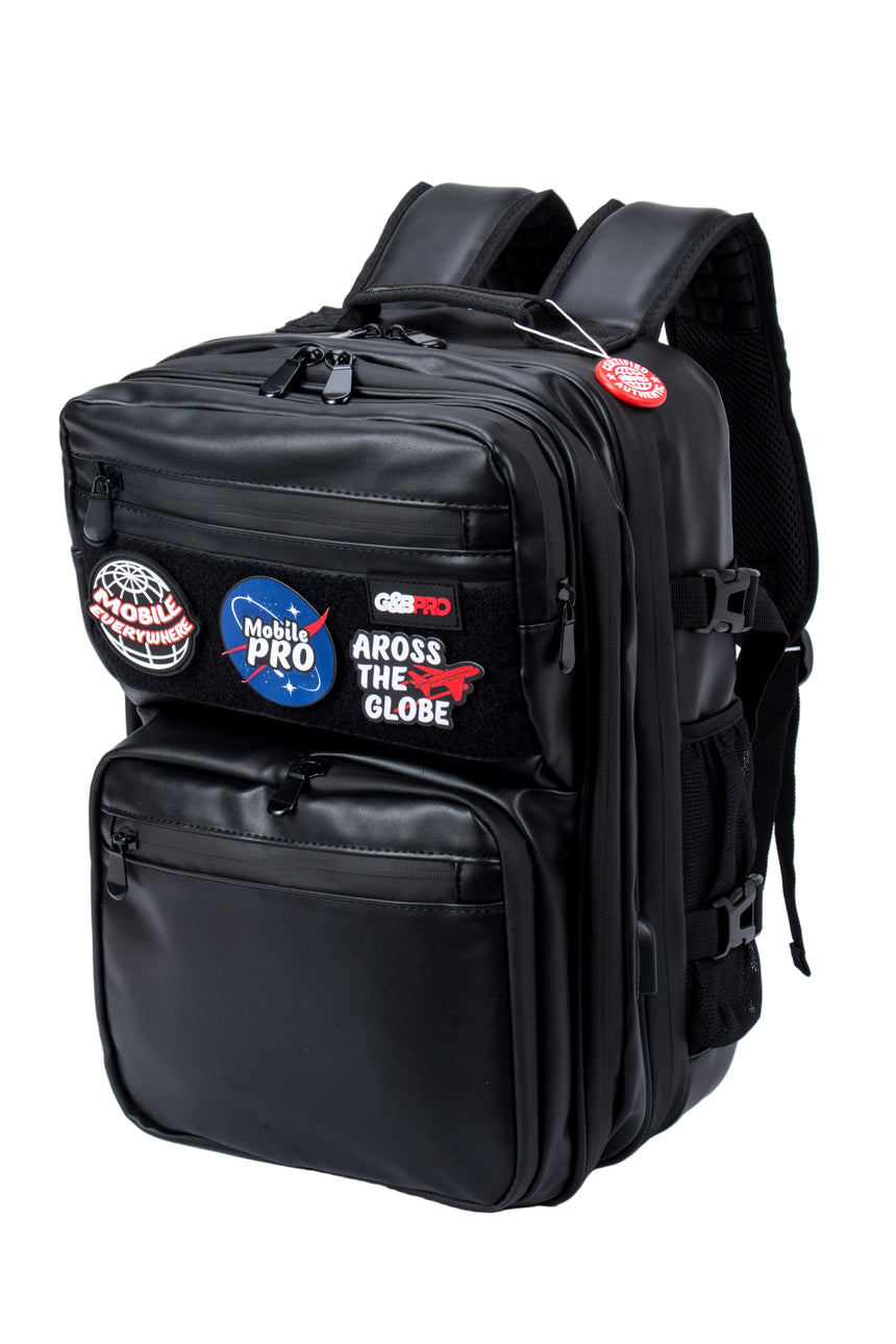 Black backpack with various patches on a white background