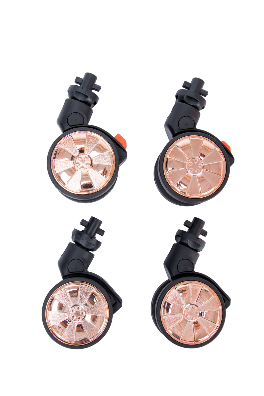 Four metallic wheel assemblies on a white background