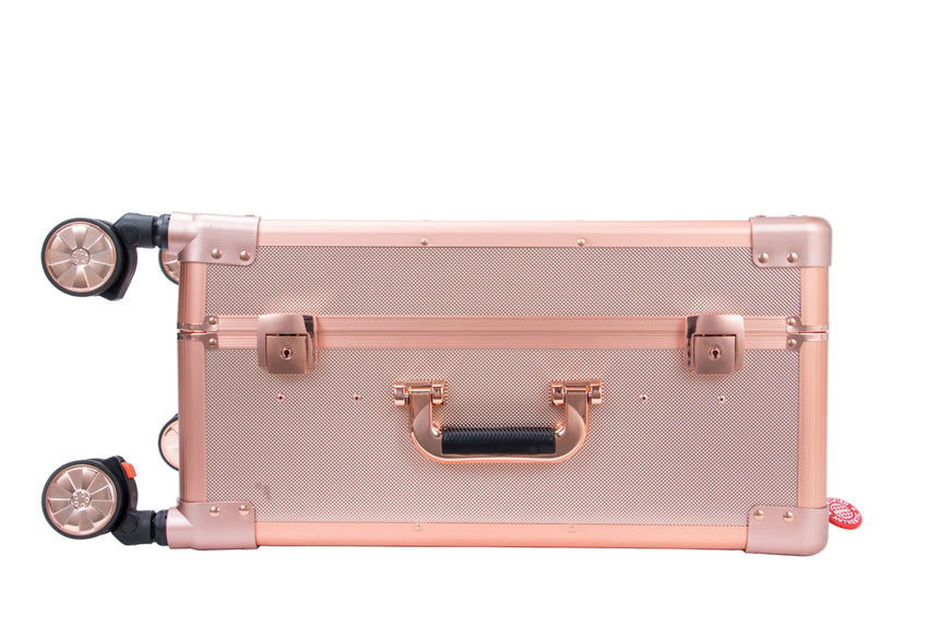 Rose gold suitcase with black handle on a white background
