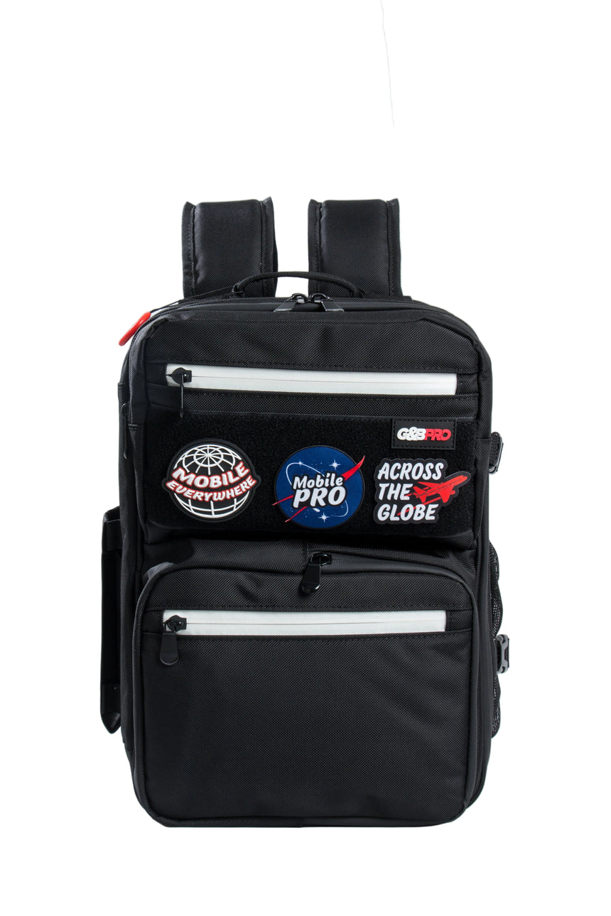 Black backpack with various patches on a white background