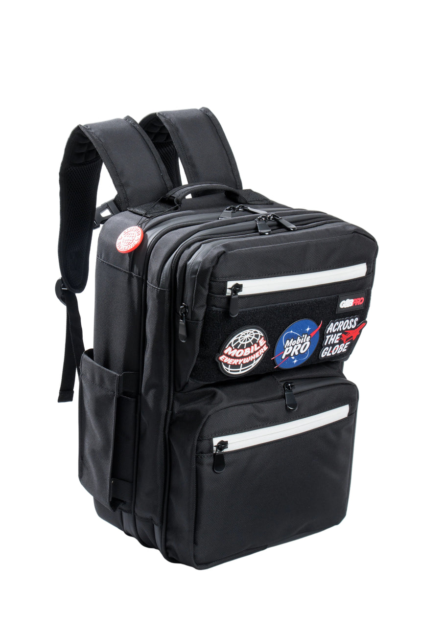 Black backpack with various patches on a white background