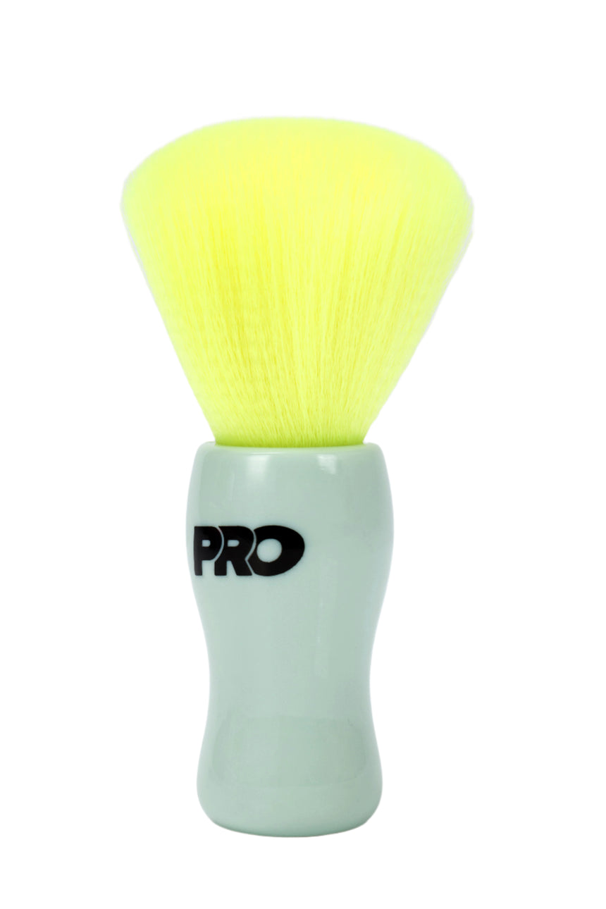 Cosmetic brush with yellow bristle head and green handle on a white background