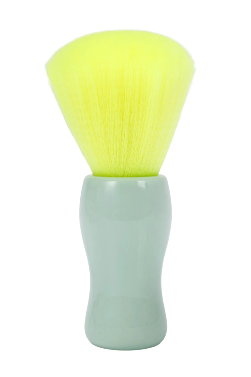 Cosmetic brush with yellow bristles and a light green handle on a white background